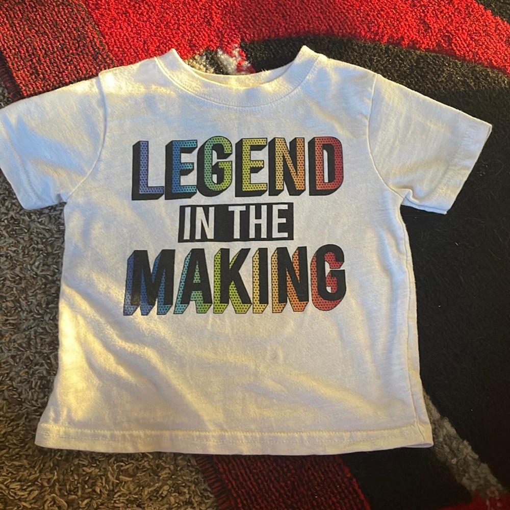 White “legend In the making” shirt, has 2 stains. Size 12M